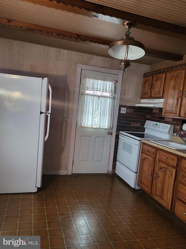 kitchen with light countertops, white appliances, brown cabinets, and under cabinet range hood