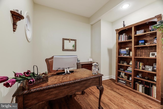 office space featuring baseboards, wood finished floors, and recessed lighting