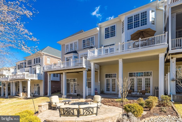 rear view of house featuring french doors and a patio area