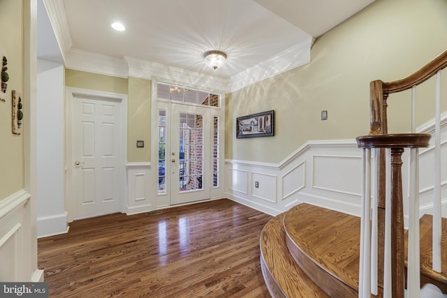 foyer featuring ornamental molding, wood finished floors, stairs, a decorative wall, and recessed lighting