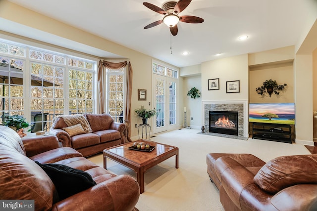 carpeted living area with recessed lighting, a fireplace, baseboards, and ceiling fan