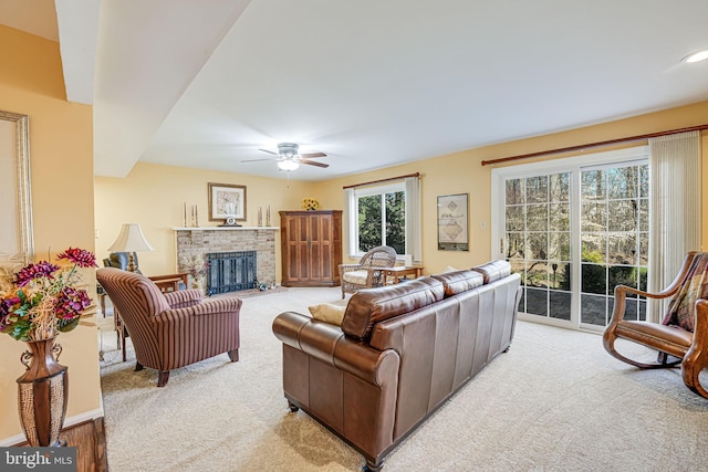 carpeted living area featuring a brick fireplace, recessed lighting, and a ceiling fan