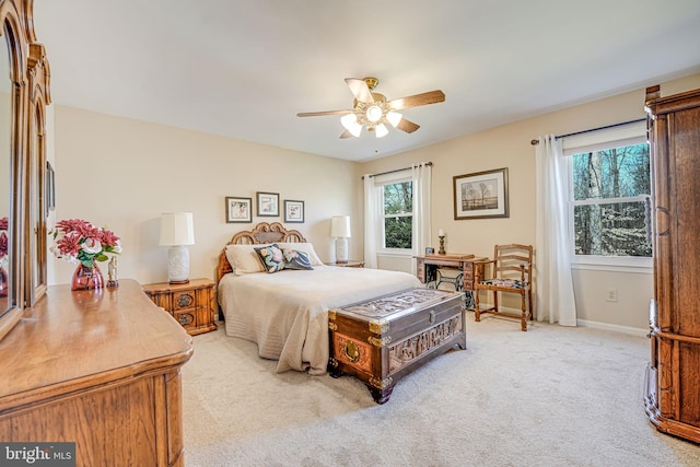 bedroom with baseboards, light carpet, and ceiling fan