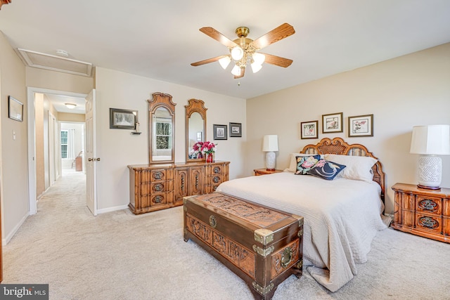 bedroom with a ceiling fan, attic access, carpet, and baseboards