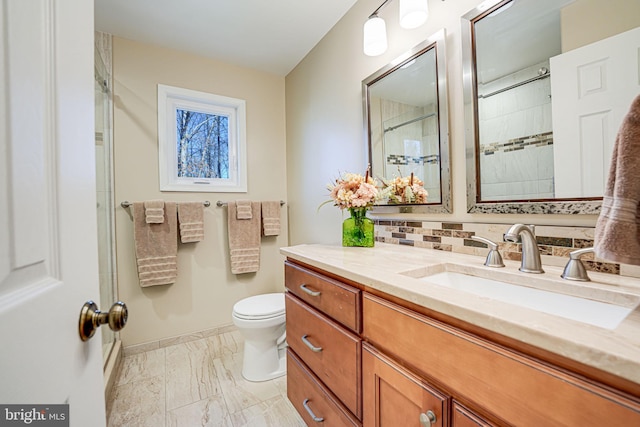 bathroom with toilet, marble finish floor, tasteful backsplash, baseboards, and vanity