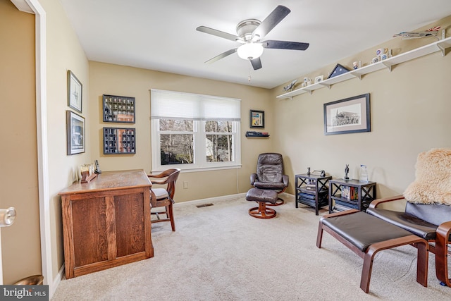 office with baseboards, carpet, visible vents, and ceiling fan