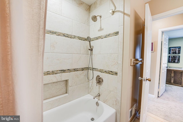 bathroom with washtub / shower combination and visible vents