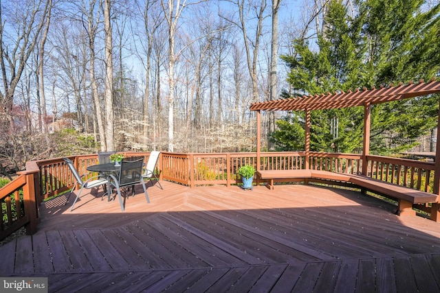 wooden deck featuring outdoor dining area and a pergola