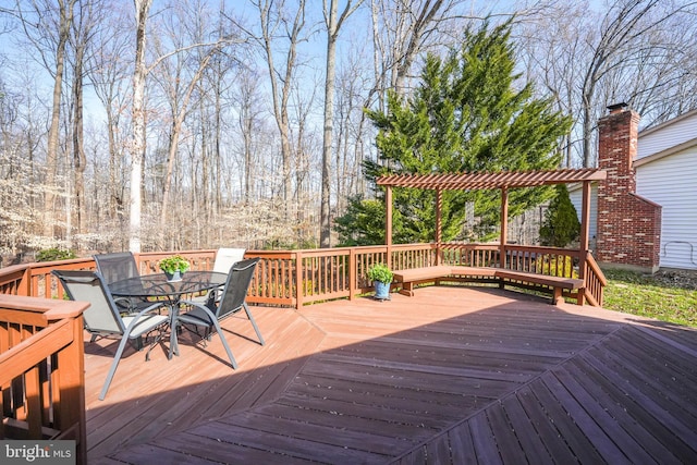 wooden deck with outdoor dining space and a pergola