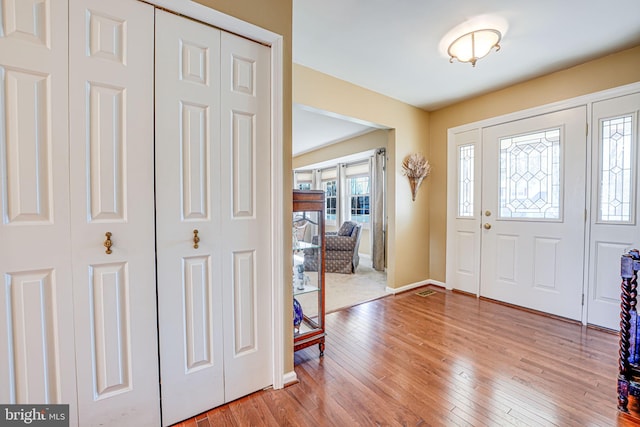 entryway featuring baseboards and light wood-style floors