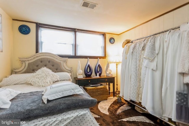 bedroom with visible vents and crown molding