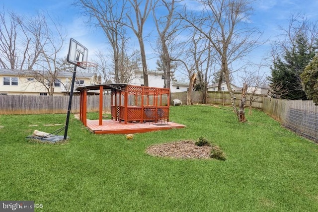 view of yard with a fenced backyard and a wooden deck