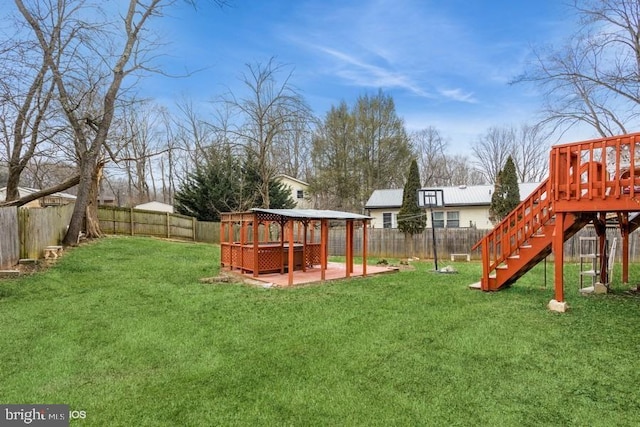 view of jungle gym featuring a patio area, a fenced backyard, and a yard