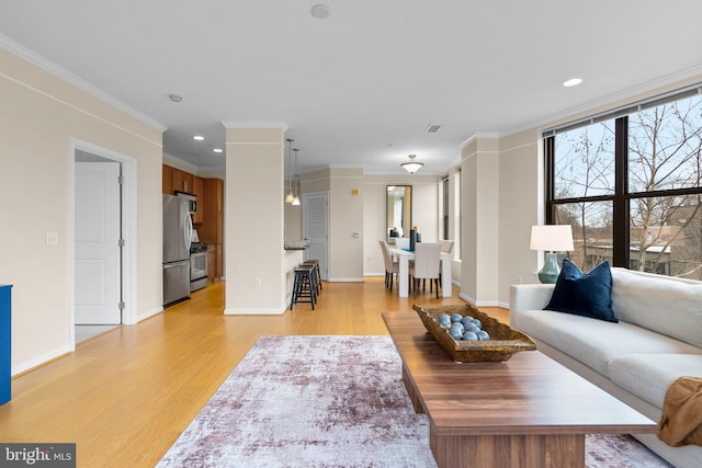 living room with crown molding, recessed lighting, visible vents, light wood-style floors, and baseboards