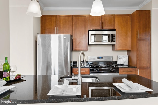 kitchen featuring stainless steel appliances, dark stone countertops, and pendant lighting