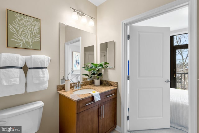 bathroom featuring vanity and toilet