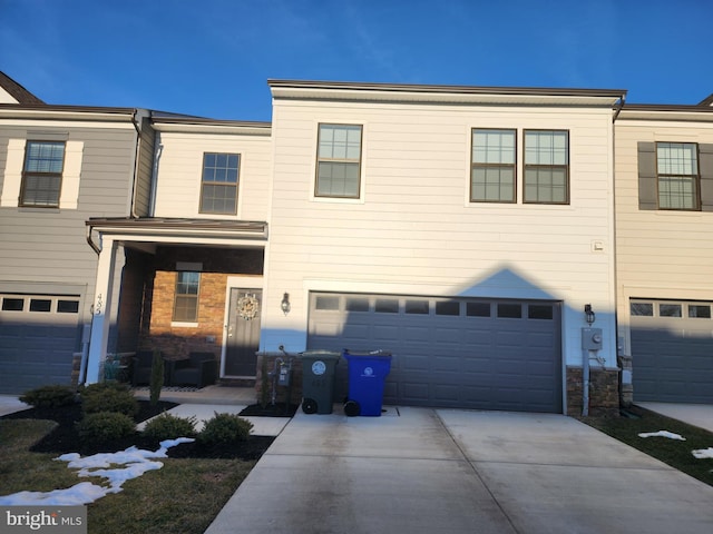 view of property with driveway and a garage