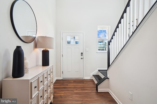 entrance foyer with stairway, baseboards, and dark wood-type flooring