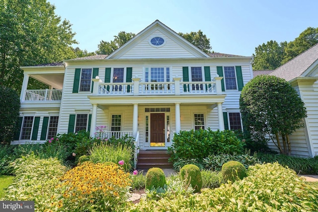 view of front of house featuring covered porch and a balcony