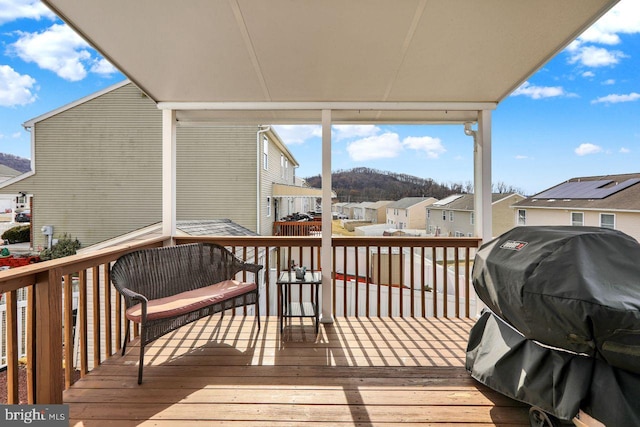 deck featuring area for grilling and a residential view