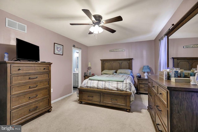 bedroom featuring baseboards, visible vents, connected bathroom, and light colored carpet