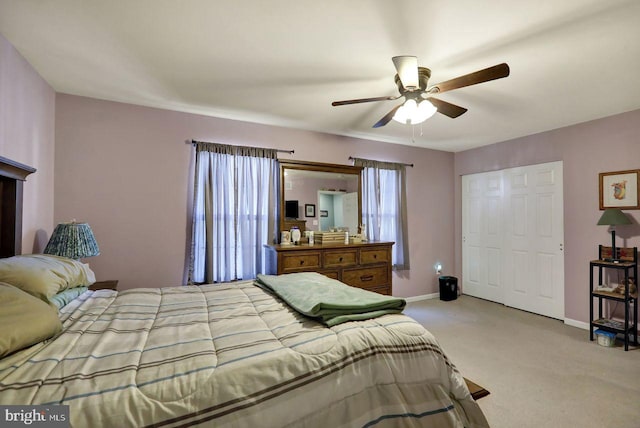 bedroom with baseboards, a ceiling fan, and light colored carpet