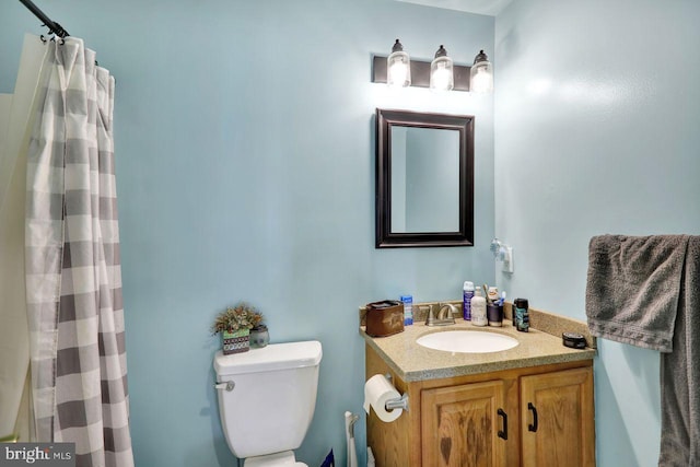 bathroom featuring toilet and vanity