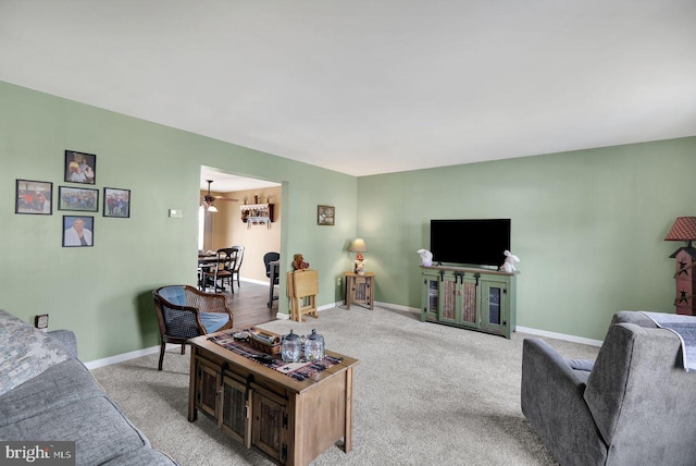 living area with light carpet and baseboards