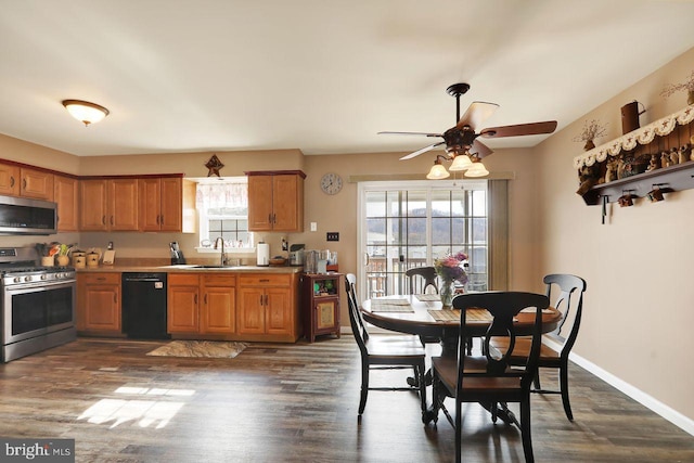 kitchen featuring a sink, brown cabinets, stainless steel appliances, and light countertops