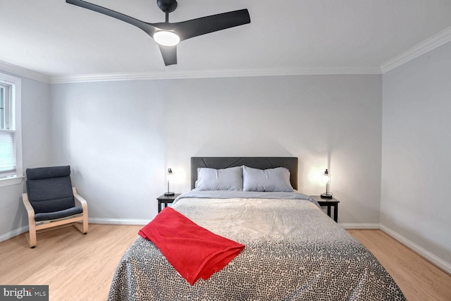 bedroom with ornamental molding, ceiling fan, light wood finished floors, and baseboards