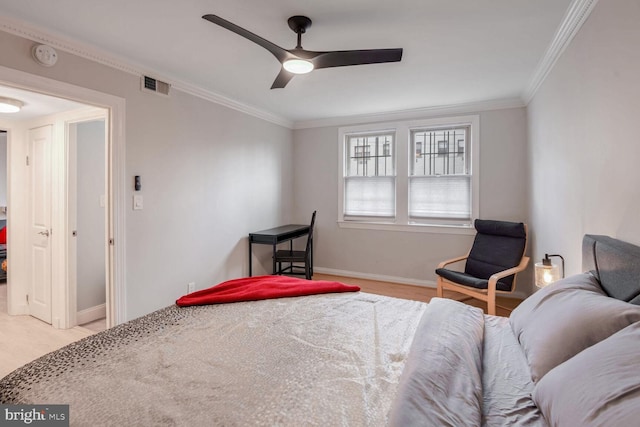 bedroom with baseboards, visible vents, light colored carpet, ceiling fan, and crown molding