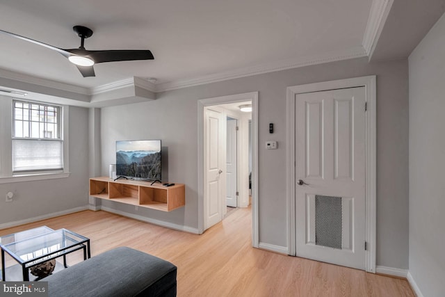 living area featuring light wood finished floors, baseboards, visible vents, a ceiling fan, and ornamental molding