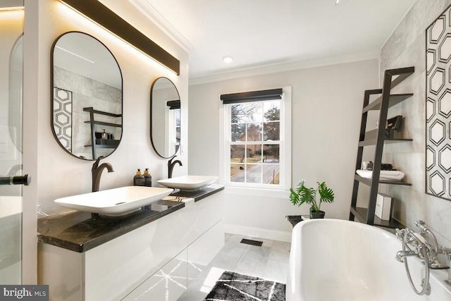 full bathroom with ornamental molding, visible vents, a sink, and a freestanding bath