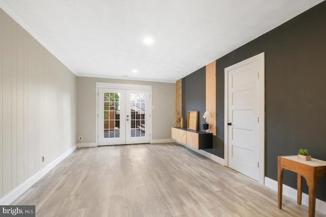 interior space with ornamental molding, french doors, light wood-type flooring, and baseboards