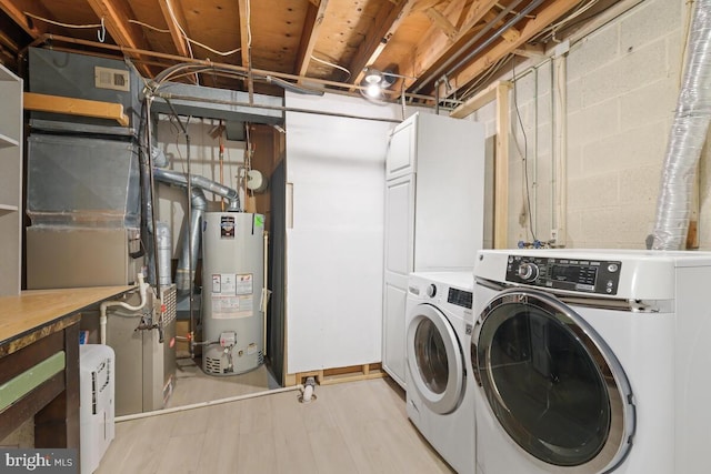 laundry room with water heater, laundry area, washer and clothes dryer, and light wood-style flooring