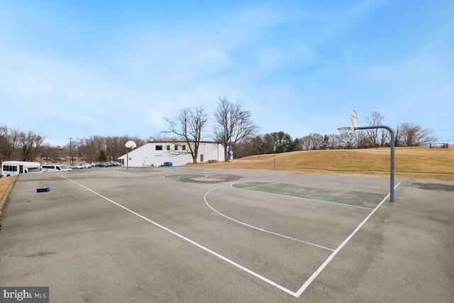 view of sport court featuring community basketball court and a lawn