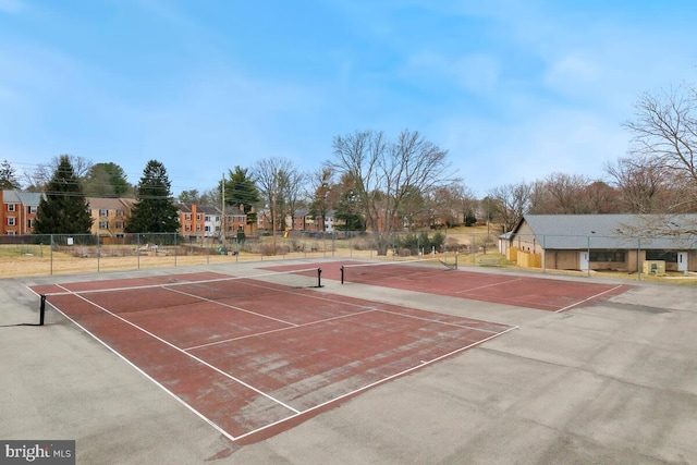 view of sport court featuring fence