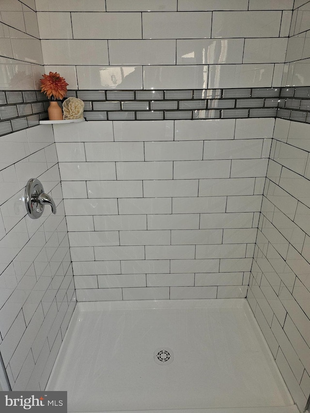bathroom with tiled shower
