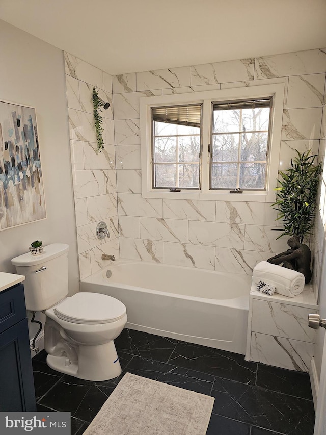 full bath featuring toilet, marble finish floor, tub / shower combination, and vanity