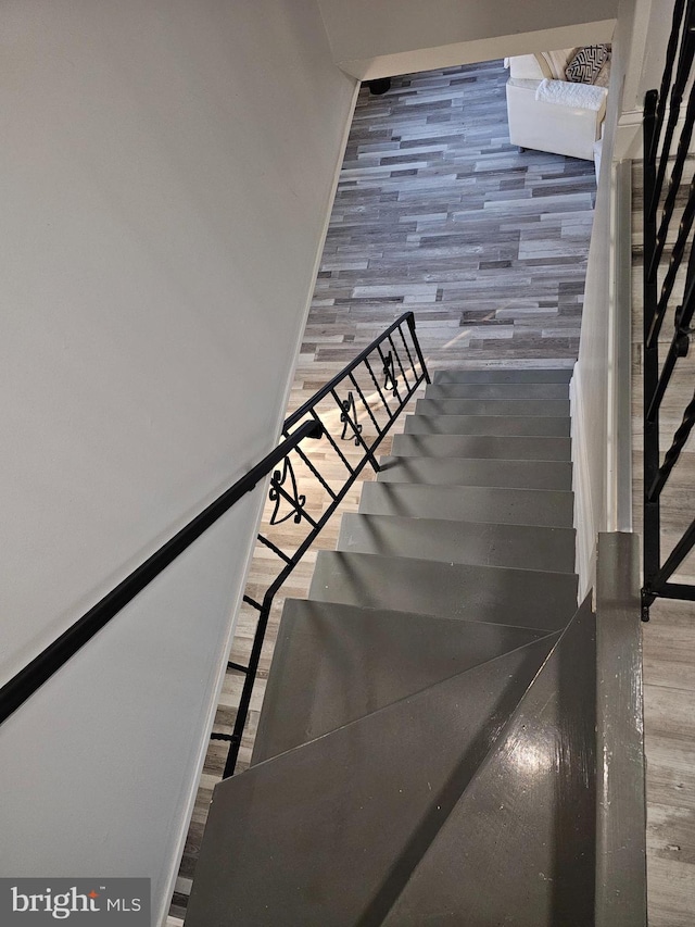 staircase featuring wood finished floors