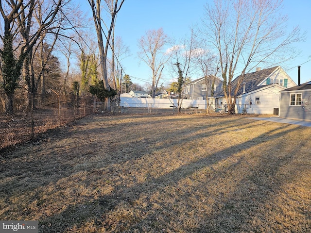 view of yard with a residential view and fence