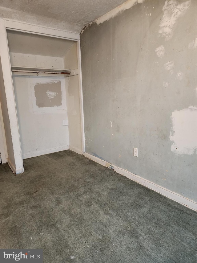 unfurnished bedroom featuring a closet and carpet flooring