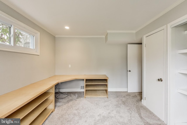 unfurnished office featuring built in desk, recessed lighting, light colored carpet, ornamental molding, and baseboards