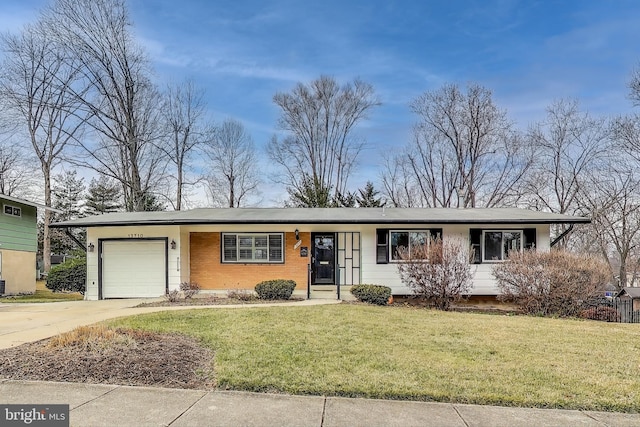 ranch-style home with a garage, a front lawn, concrete driveway, and brick siding