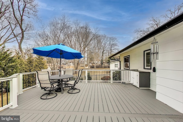 wooden deck featuring outdoor dining area