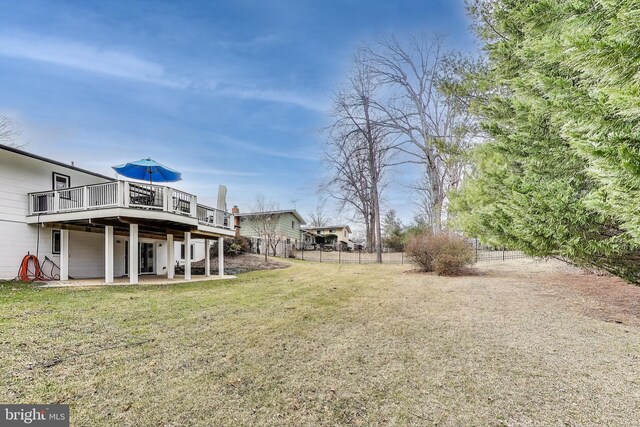 view of yard with a patio area, fence, and a deck