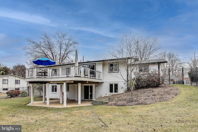 back of house with a patio, fence, a wooden deck, and a lawn