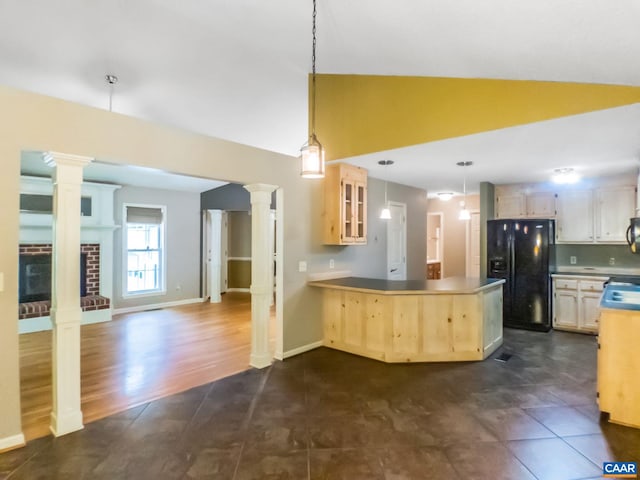 kitchen with ornate columns, glass insert cabinets, black refrigerator with ice dispenser, and light brown cabinetry