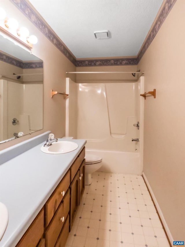 bathroom featuring toilet, tile patterned floors, crown molding, vanity, and shower / washtub combination