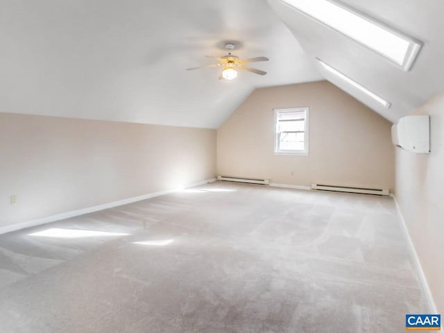 additional living space featuring a baseboard heating unit, a wall mounted air conditioner, and baseboards